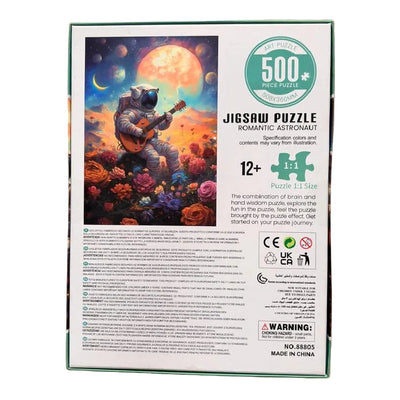 A 500-piece jigsaw puzzle box featuring a colorful illustration of an astronaut floating in space while playing a guitar