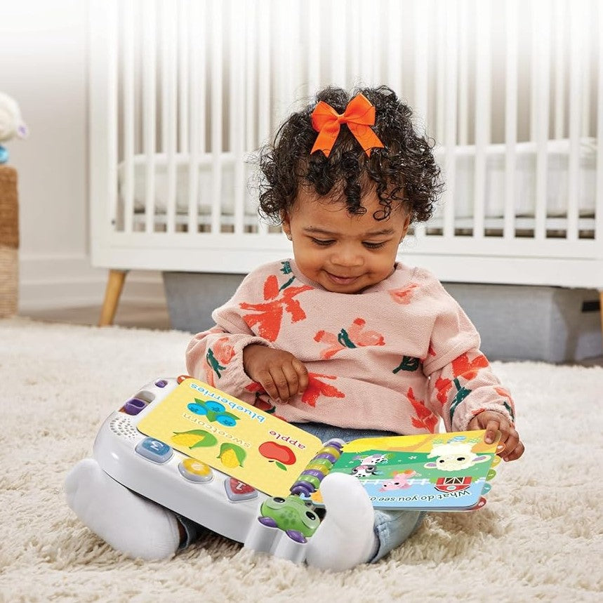 Child playing with a toy piano and book in a nursery