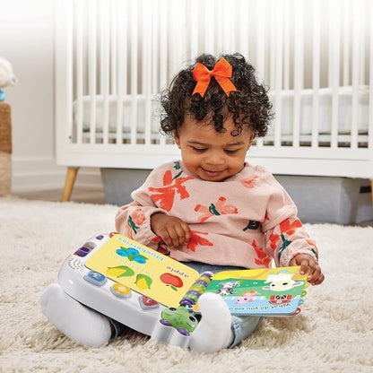 Child playing with a toy piano and book in a nursery