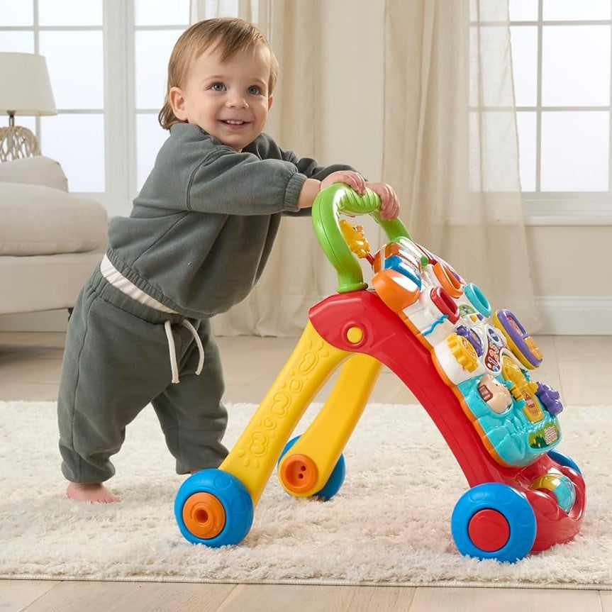 Child playing with a colorful toy walker in a living room.